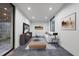 Bright living room with a white sectional sofa, modern decor, and access to an outdoor area at 4908 Birchleaf Dr, Raleigh, NC 27606