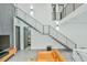 Modern living room features sleek black metal staircase and access to the ensuite bathroom at 4908 Birchleaf Dr, Raleigh, NC 27606