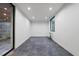Empty room showcasing ample space, a modern window, and access to an outdoor deck with wooded views at 4908 Birchleaf Dr, Raleigh, NC 27606