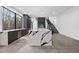 Spacious open concept living area features a modern kitchen, sleek staircase, and concrete flooring at 4908 Birchleaf Dr, Raleigh, NC 27606