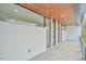 Outdoor patio with minimalist design, featuring large glass doors and sleek railing system at 4908 Birchleaf Dr, Raleigh, NC 27606