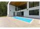 The modern backyard features a rectangular pool with tanning ledge and a covered patio at 4908 Birchleaf Dr, Raleigh, NC 27606