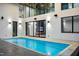 A pristine, modern pool with a tanning ledge is seamlessly integrated with the home's architecture at 4908 Birchleaf Dr, Raleigh, NC 27606