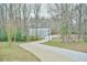 Private driveway leading to a contemporary home nestled among mature trees and greenery at 4908 Birchleaf Dr, Raleigh, NC 27606