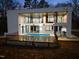 Striking modern home featuring a private pool, large windows, and outdoor living spaces at 4908 Birchleaf Dr, Raleigh, NC 27606