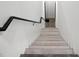 Minimalist staircase with concrete steps and a black metal handrail at 4908 Birchleaf Dr, Raleigh, NC 27606
