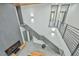 High angle view of a multi-level home showcasing modern staircases, a living area with a TV, and unique lighting fixtures at 4908 Birchleaf Dr, Raleigh, NC 27606