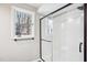 Modern bathroom featuring subway tile shower with glass door and window at 5017 Pine Cone Dr, Durham, NC 27707