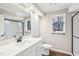 Bathroom featuring a large mirror, modern vanity, and updated shower at 5017 Pine Cone Dr, Durham, NC 27707