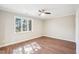 Spacious bedroom with ceiling fan, neutral paint, and large window at 5017 Pine Cone Dr, Durham, NC 27707