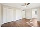 Bedroom with a ceiling fan, white closet doors, and neutral paint at 5017 Pine Cone Dr, Durham, NC 27707
