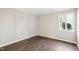 This bedroom features neutral walls, wood-look floors and a bright window at 5017 Pine Cone Dr, Durham, NC 27707