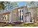 Two-story home exterior featuring a large window and a utility access door at 5017 Pine Cone Dr, Durham, NC 27707