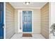 A well-lit front door with a fresh coat of paint and a welcome mat at 5017 Pine Cone Dr, Durham, NC 27707