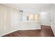 Spacious living room with wood floors and light gray walls and trim at 5017 Pine Cone Dr, Durham, NC 27707