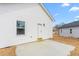 Exterior of home featuring a concrete patio, and new vinyl siding with green yard at 603 Lee St, Burlington, NC 27217