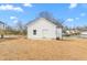 Rear of home featuring a concrete patio, green yard, new roof and new vinyl siding at 603 Lee St, Burlington, NC 27217