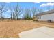 Backyard of home with green yard, concrete patio, and newly installed vinyl siding at 603 Lee St, Burlington, NC 27217