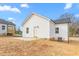 Exterior of home showing a green backyard, concrete patio, and new vinyl siding at 603 Lee St, Burlington, NC 27217