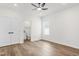 Spacious bedroom with ceiling fan, wood-look flooring, and ensuite bathroom at 603 Lee St, Burlington, NC 27217