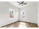 Bright bedroom with wood-look flooring and two windows for natural light at 603 Lee St, Burlington, NC 27217
