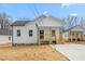 Charming home with new front porch, railing, sidewalk and fresh sod on a sunny day at 603 Lee St, Burlington, NC 27217