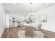 Open-concept kitchen featuring stainless steel appliances, white cabinets, and a stylish dining area at 603 Lee St, Burlington, NC 27217