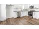 Bright kitchen featuring white cabinets, stainless steel appliances, and granite countertops at 603 Lee St, Burlington, NC 27217