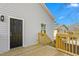 Back deck of home with wood decking and railings and door to home at 605 Lee St, Burlington, NC 27215