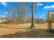 The expansive backyard features mature trees and partial views of the deck at 605 Lee St, Burlington, NC 27215