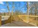 Backyard deck with wood railings and stairs leading to the yard at 605 Lee St, Burlington, NC 27215