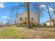 The backyard features a wooden deck and mature trees at 605 Lee St, Burlington, NC 27215