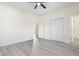 Large bedroom with a ceiling fan, double closets, and stylish flooring at 605 Lee St, Burlington, NC 27215