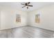 Spacious bedroom featuring two bright windows, ceiling fan, and stylish flooring at 605 Lee St, Burlington, NC 27215