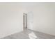 Bedroom with light gray wood-look flooring and a door leading to another room at 605 Lee St, Burlington, NC 27215