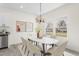 Elegant dining area featuring a modern chandelier, a marble-top table, and bright windows at 605 Lee St, Burlington, NC 27215