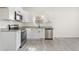 Charming kitchen features white cabinets, granite countertops, and stainless steel appliances at 605 Lee St, Burlington, NC 27215
