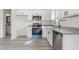 Well-equipped kitchen with stainless steel appliances, granite countertops, and bright white cabinetry at 605 Lee St, Burlington, NC 27215