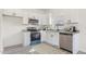 Stylish kitchen features white cabinets, granite counters, stainless steel appliances, and ample natural light at 605 Lee St, Burlington, NC 27215