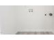 Bright, blank laundry room with new flooring and essential utility connections ready for appliance hookups at 605 Lee St, Burlington, NC 27215