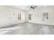 Open-concept living space with white walls, hardwood floors, and lots of natural light at 605 Lee St, Burlington, NC 27215