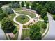 Aerial view of common area with manicured landscaping, walkways, and a covered gazebo in a park-like setting at 696 The Parks Dr, Pittsboro, NC 27312