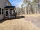 Large backyard with a screened porch and a wooded area, offers ample space for outdoor activities and relaxation at 696 The Parks Dr, Pittsboro, NC 27312
