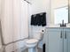 Bathroom with a toilet, shower with white curtain, and vanity with light blue cabinets and matte black faucet at 696 The Parks Dr, Pittsboro, NC 27312