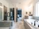 Bathroom features a glass shower, soaking tub with tiled surround, and double sink vanity at 696 The Parks Dr, Pittsboro, NC 27312
