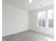 Empty bedroom featuring gray carpet, white walls, and two windows that provide ample natural light at 696 The Parks Dr, Pittsboro, NC 27312