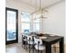 Elegant dining room with a modern light fixture and view to screened porch at 696 The Parks Dr, Pittsboro, NC 27312