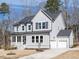 Charming two-story home featuring a manicured lawn, covered porch, and attached two car garage at 696 The Parks Dr, Pittsboro, NC 27312