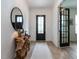 Foyer showcasing a rustic table, unique mirror, and a view of the front door at 696 The Parks Dr, Pittsboro, NC 27312