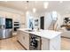 Bright kitchen with a large island, stainless steel appliances, and adjacent staircase at 696 The Parks Dr, Pittsboro, NC 27312